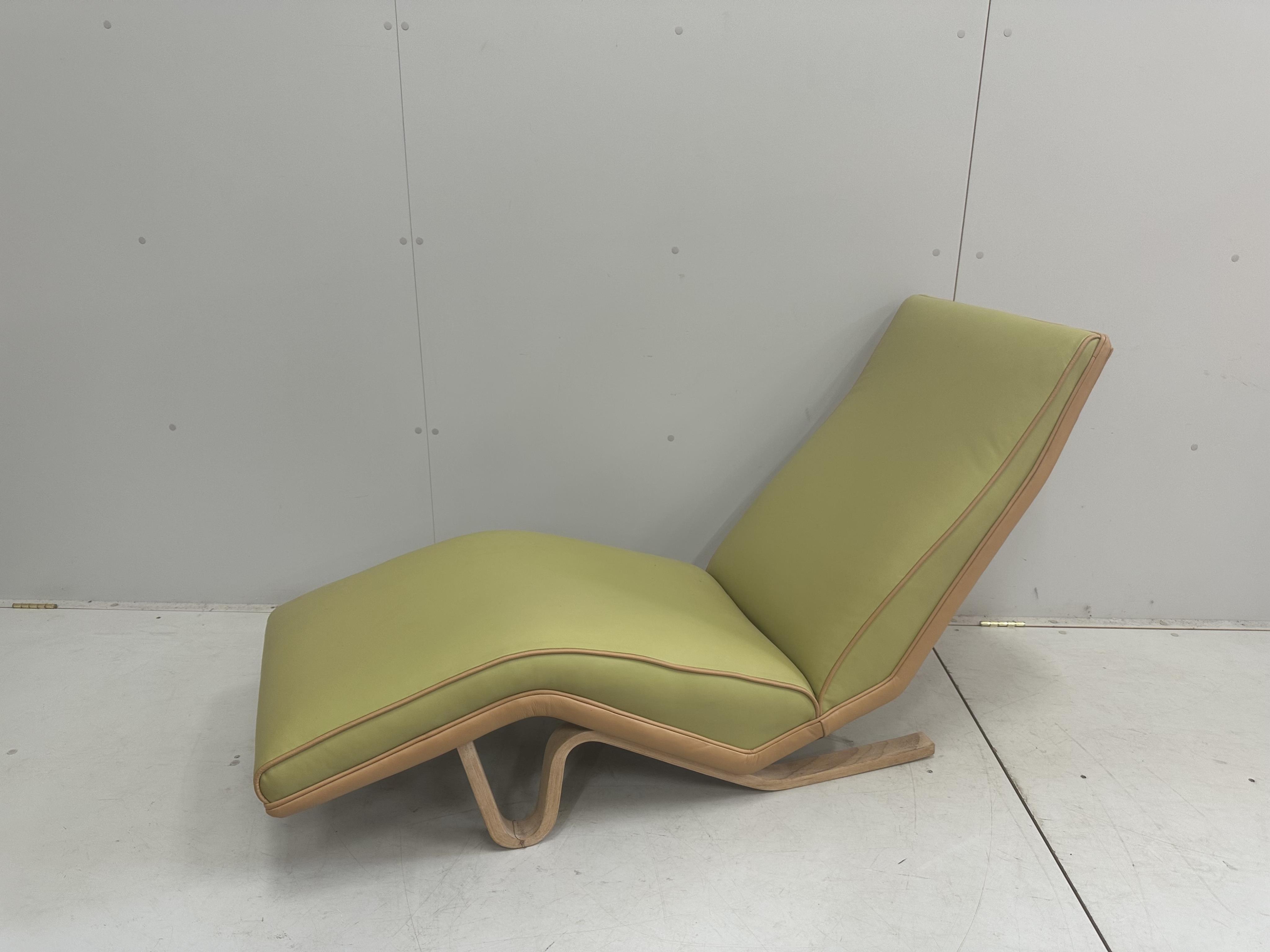 Andrew Milne, a long chair recently re-upholstered in pale green and brown leather, width 138cm, depth 52cm, height 80cm. Condition - good